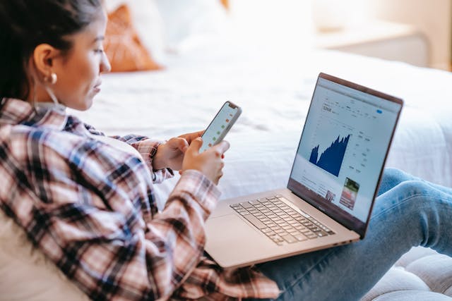 person on a laptop watching market changes